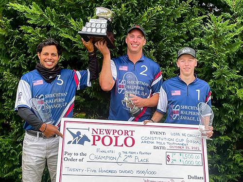 Constitution Cup Winning Team holding individual player trophies, perpetual cup, and presentation check.